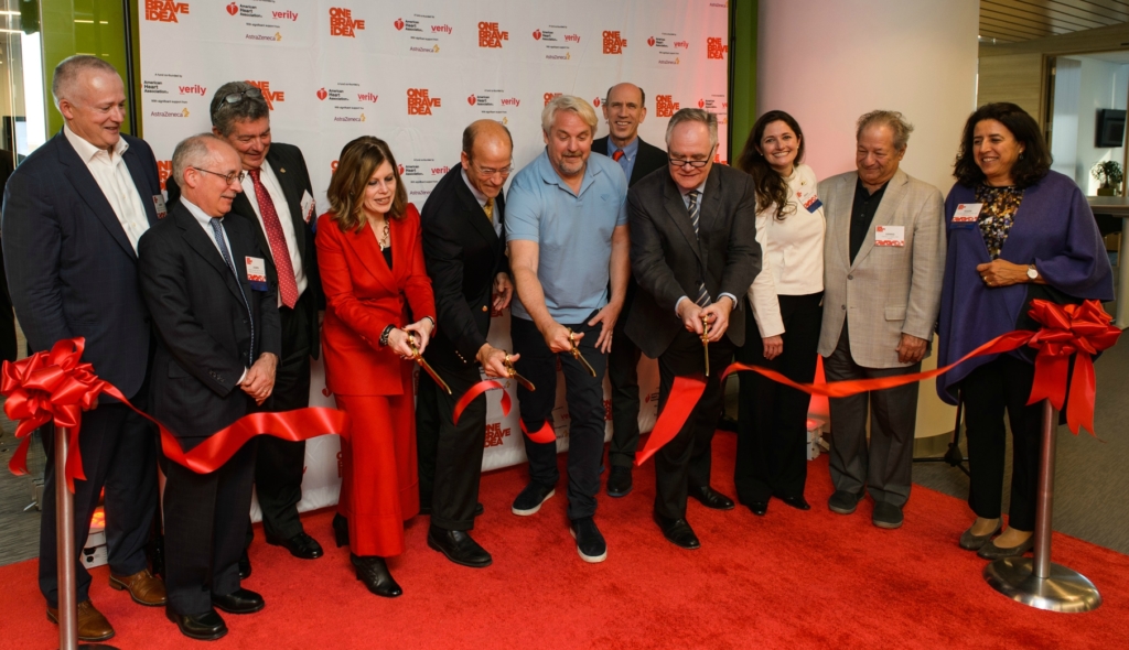 AHA CEO Nancy Brown (in red), Greg Keenan of AstraZeneca, Andy Conrad of Verily and One Brave Idea leader Calum MacRae cut the ribbon on the One Brave Idea Science Innovation Center.